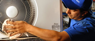 Empleado terminando la instalación de un aire acondicionado